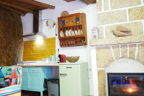 a kitchen with a white refrigerator and a stove at Artsy Short Term Rentals Monsanto in Monsanto