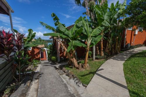 a sidewalk with a bunch of banana trees next to a house at Muri Motu Outlook in Rarotonga