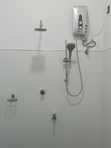a bathroom with a blow dryer on the wall at Green Ocean Bay in Arugam Bay