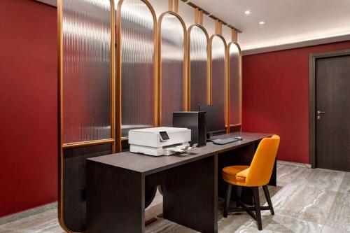 an office with a desk with a computer on it at Athens Key Hotel, Trademark Collection by Wyndham in Athens