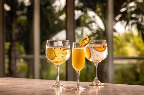 three glasses of wine sitting on a table at Santa Marta Marriott Resort Playa Dormida in Santa Marta
