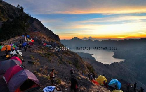 a group of people standing on top of a mountain at RINJANI EXPEDITION BASECAMP in Masbagik