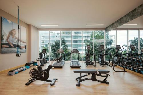 a gym with a bunch of treadmills and exercise bikes at Santa Marta Marriott Resort Playa Dormida in Santa Marta