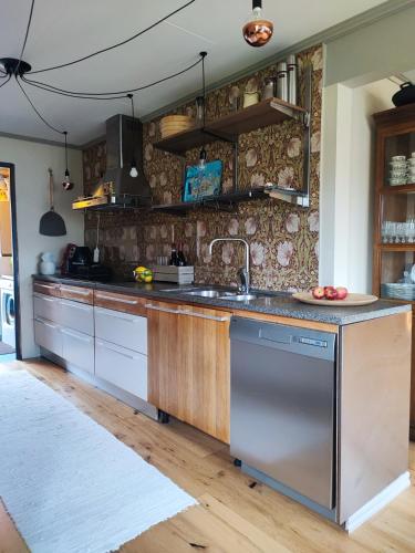 a kitchen with a sink and a counter at Villaidyll i Svanesund nära havet in Svanesund