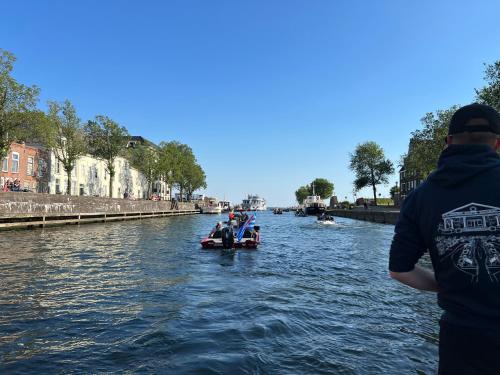a group of people in a boat on a river at Resort Citta Romana in Hellevoetsluis