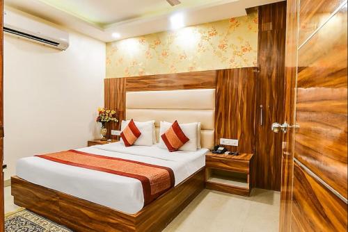 a hotel room with a bed and a glass door at Aerocity Hotel Zindal Plaza at Delhi Airport in New Delhi