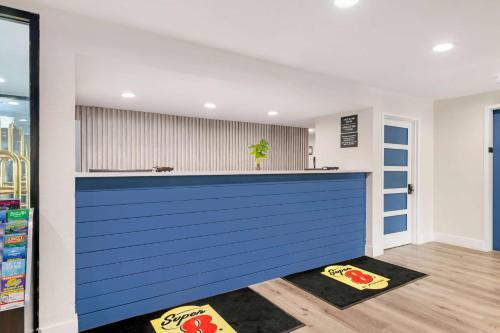 a kitchen with a blue counter in a room at Super 8 by Wyndham Orlando Near Florida Mall in Orlando