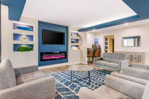 a living room with a couch and a tv at Super 8 by Wyndham Orlando Near Florida Mall in Orlando