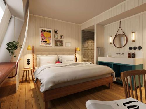 a bedroom with a large bed and a bathroom at 25hours Hotel Paper Island in Copenhagen