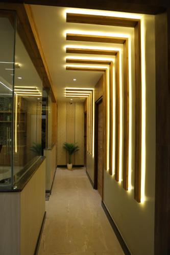 a hallway of an office building with a potted plant at Mount Grande "formerly known as Miot Grande" in Chennai