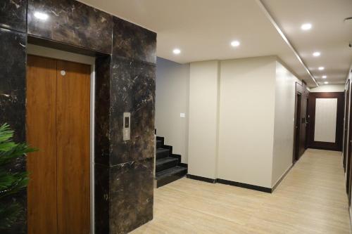 a hallway with a stair case and a hallway with a door at Miot Grande in Chennai