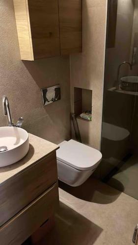 a bathroom with a white toilet and a sink at Casa pi in Bunyola