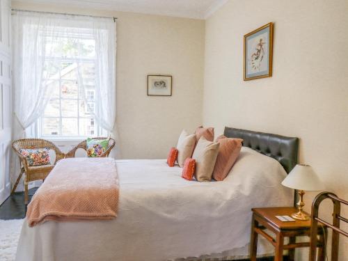 a bedroom with a large bed with pillows on it at Victoria House in Alnwick