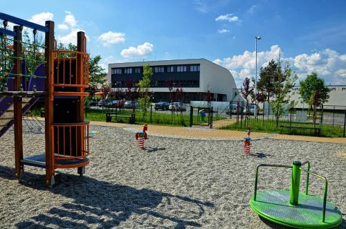 a playground with a slide and a swing set at Hotel Bażantowo Sport in Katowice