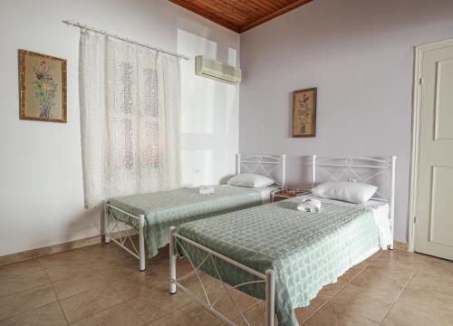 a bedroom with two beds and a window at Aneza in Kremasti