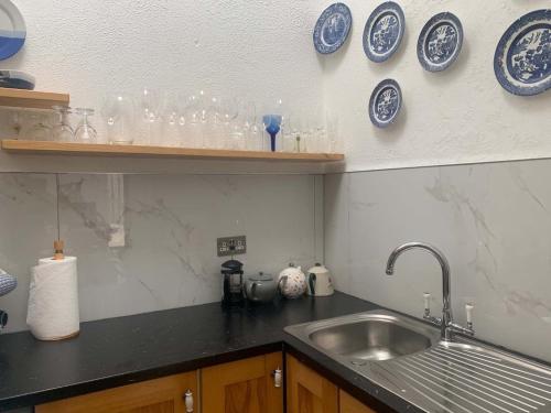 a kitchen with blue and white plates and a sink at Bayview, Dunmore East, County Waterford - Sleeps 12 persons in Dunmore East