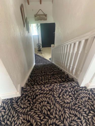 a staircase with a bed in a room at Bayview, Dunmore East, County Waterford - Sleeps 12 persons in Dunmore East