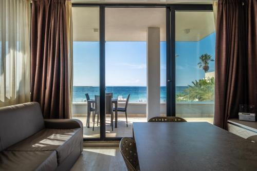 a living room with a view of the ocean at Residence Picalè in Alghero