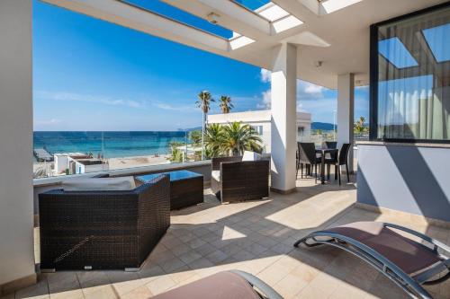 an outdoor patio with a view of the ocean at Residence Picalè in Alghero