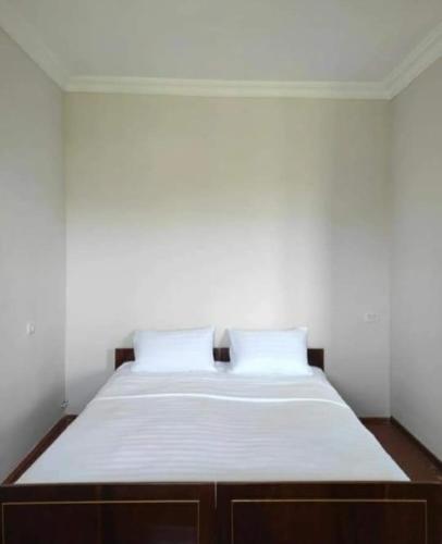 a white bed with two pillows in a room at MG Guest House in Ijevan
