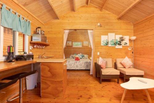 a kitchen and living room in a log cabin at Muri Motu Outlook in Rarotonga