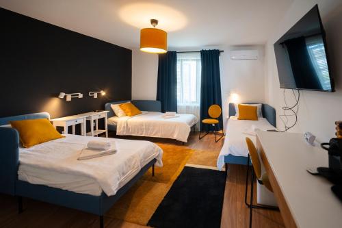 Habitación pequeña con 2 camas y mesa. en Cozy Nook, en Novi Sad