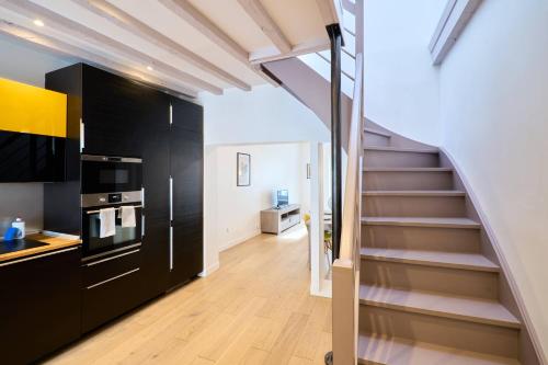 a kitchen with a staircase leading to a living room at LE BLUM COEUR - Hyper Centre Nantes in Nantes