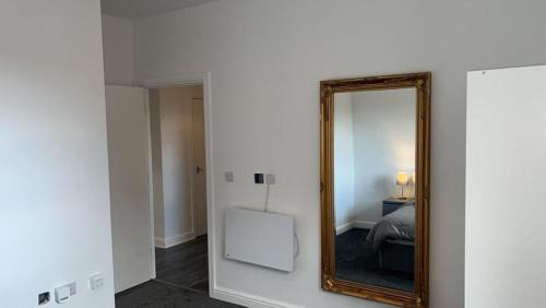 a mirror on a wall in a room with a bed at Beautiful 1-Bed Apartment in Tipton in Tipton