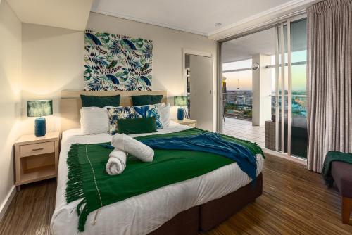 a bedroom with a large bed and a balcony at Luxury Oasis with Indulgent River Views in Brisbane