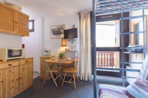 a small kitchen with a table in a room at Plein Sud - 1501 - Studio pied des pistes 2 pers in Les Deux Alpes