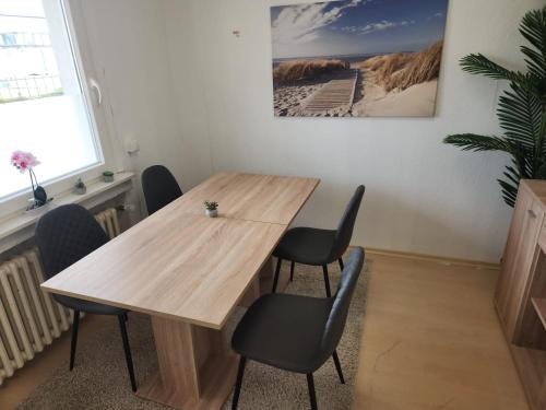 a wooden table and chairs in a room at Gästewohnung in Adolf Grimme Stadt Marl in Marl