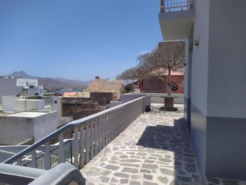 a balcony of a building with a view of a city at Vivenda com pátio, no coração do Mindelo in Mindelo