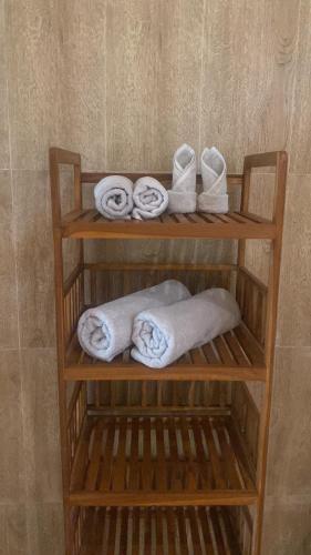 a wooden towel rack with towels and towels at Jungle Joglo in Tampaksiring