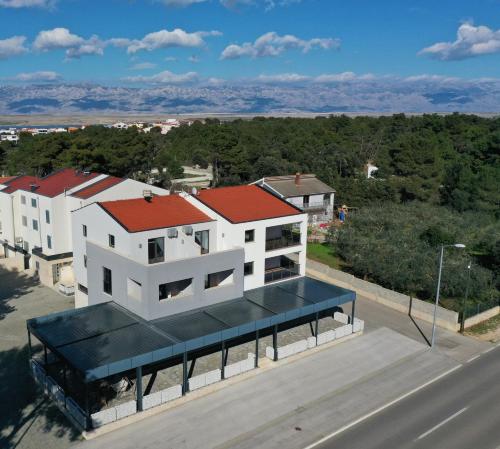 an aerial view of a white building with a red roof at APARTMANI PETRA in Vir