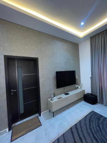 a living room with a flat screen tv on a wall at Luxury Airport residential in Accra