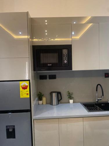 a kitchen with a microwave and a counter top at Luxury Airport residential in Accra