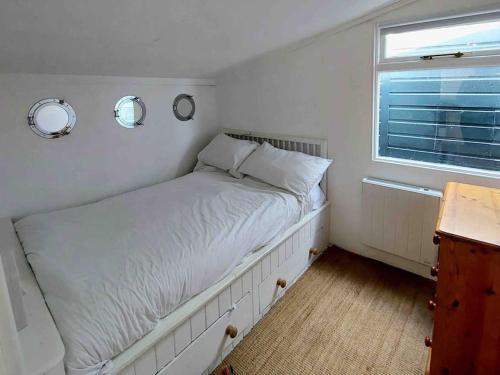 a bedroom with a bed with two mirrors on the wall at Amazing Sea View Chalet. 1 minute from the sea , harbour and Cobb and very nr to fabulous pubs , restaurants and activities. Sleeps 4 with parking in Lyme Regis