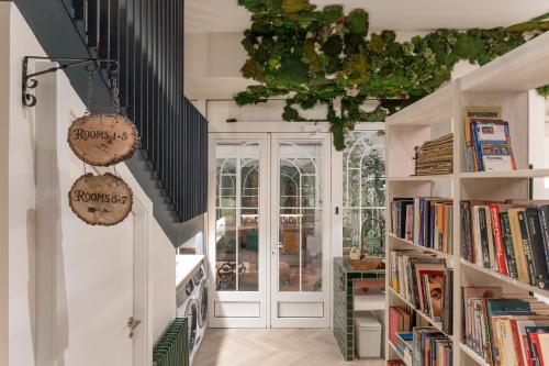 a room with bookshelves and a hallway with a door at 4 Bears Sharehome in Madrid