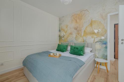una camera da letto con un letto con cuscini verdi di Cozy Apartment Orawska with Balcony by Noclegi Renters a Cracovia
