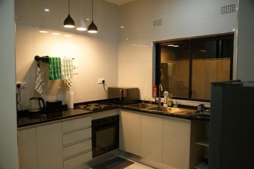 a kitchen with a sink and a counter top at Modern Village Apartments in Chipata