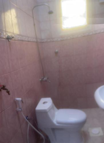 a bathroom with a toilet and a sink at شقة عائلية مفروشةFurnished family apartment for rent in Tabuk