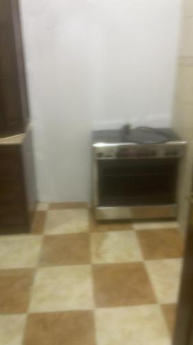 a kitchen with a toaster oven on a tiled floor at شقة عائلية مفروشةFurnished family apartment for rent in Tabuk