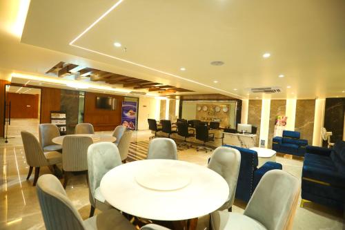a restaurant with tables and chairs and a waiting room at HOTEL SHUBHAM PALACE in Hyderabad