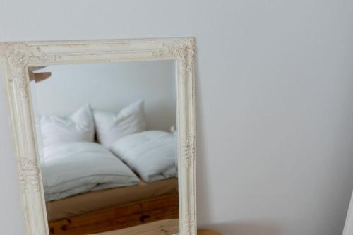 a mirror with a couch in the reflection at Bungalow mit Basketballplatz in Lemgo