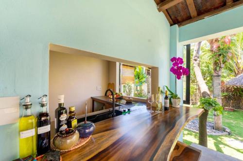 a room with a wooden table with bottles on it at Garden of Love Villa in An Bang, Hoi An in An Bang
