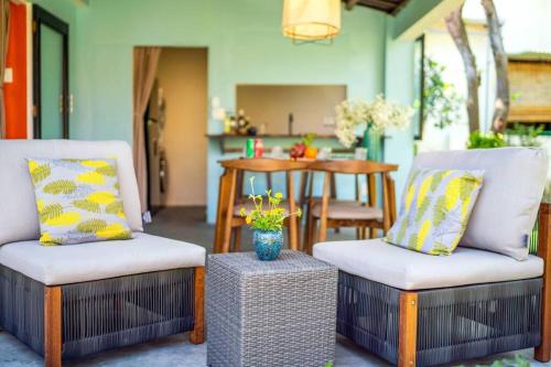 a living room with two chairs and a table at Garden of Love Villa in An Bang, Hoi An in An Bang