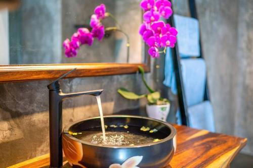 a pot of coffee on a table next to a plant at Garden of Love Villa in An Bang, Hoi An in An Bang