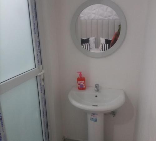 a bathroom with a white sink and a mirror at Stylish villa homes in Mombasa