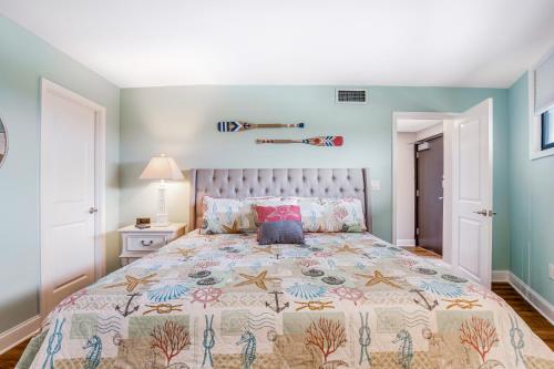 a bedroom with a large bed with blue walls at Sea Colony - 1403N Edgewater House Rd. in Bethany Beach
