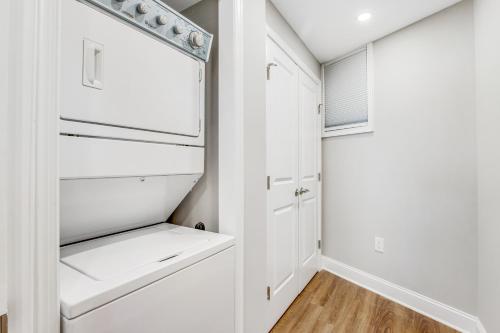 a kitchen with white cabinets and a refrigerator at Sea Colony - 1403N Edgewater House Rd. in Bethany Beach